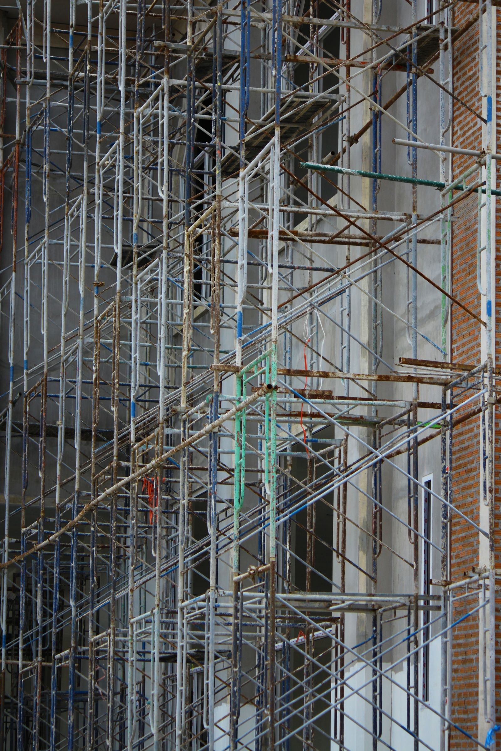Dense metal scaffolding rising across the face of a building