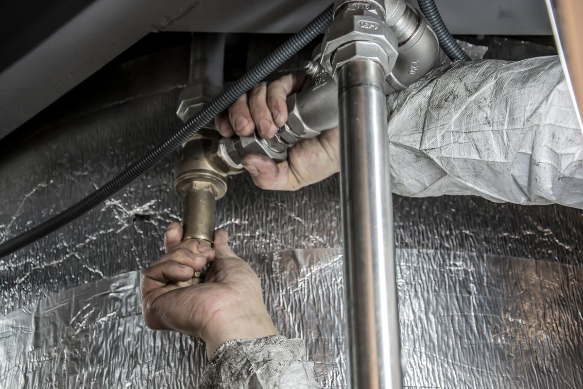 A heating engineer fitting steel pipework